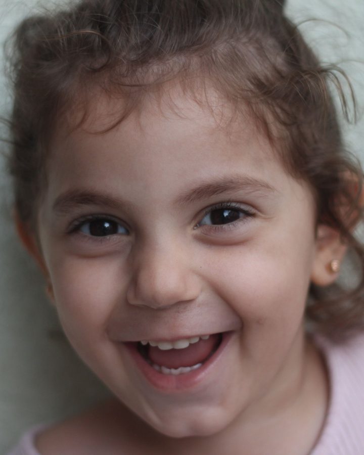 Sample Postcard photo: a smiling young girl with curly hair